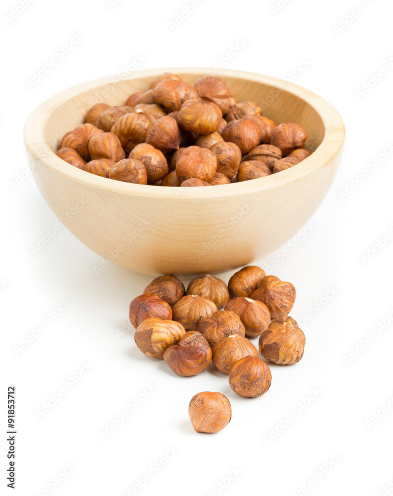 Cracked and shelled hazelnut in wooden bowl Cracked and shelled hazelnut in wooden bowl