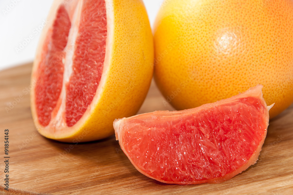 Grapefruit slice on the wooden board Grapefruit slice on the wooden board