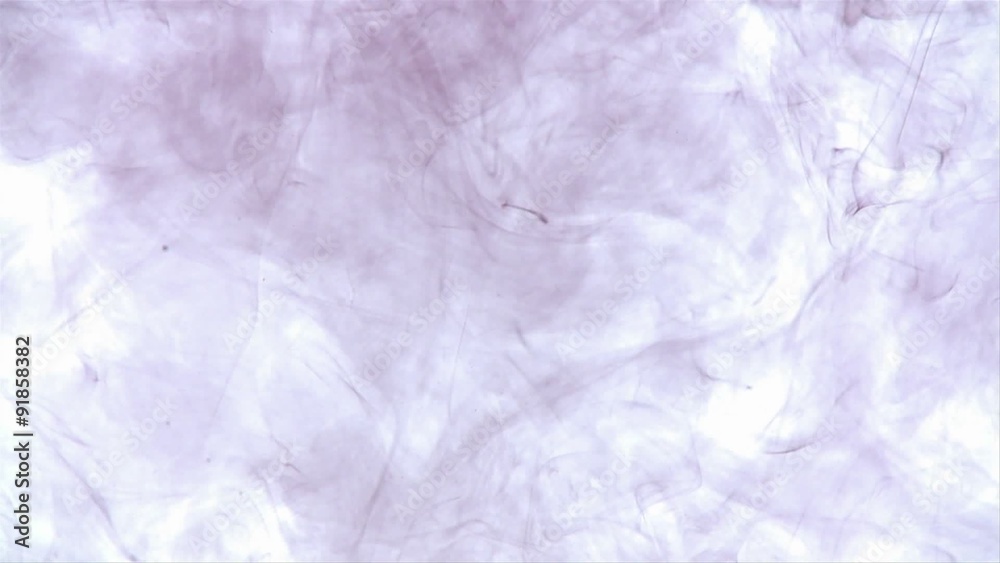 A dark ink swirls around in another liquid. A dark ink swirls around in another liquid.