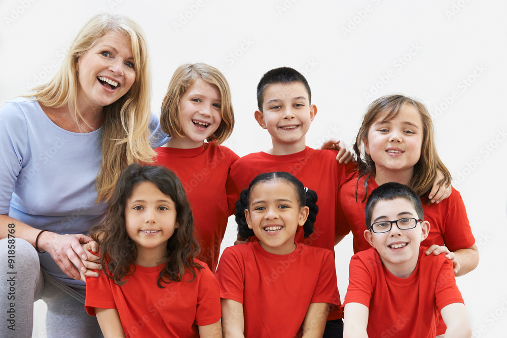 Group Of Children With Teacher Enjoying Drama Workshop Together Group Of Children With Teacher Enjoying Drama Workshop Together