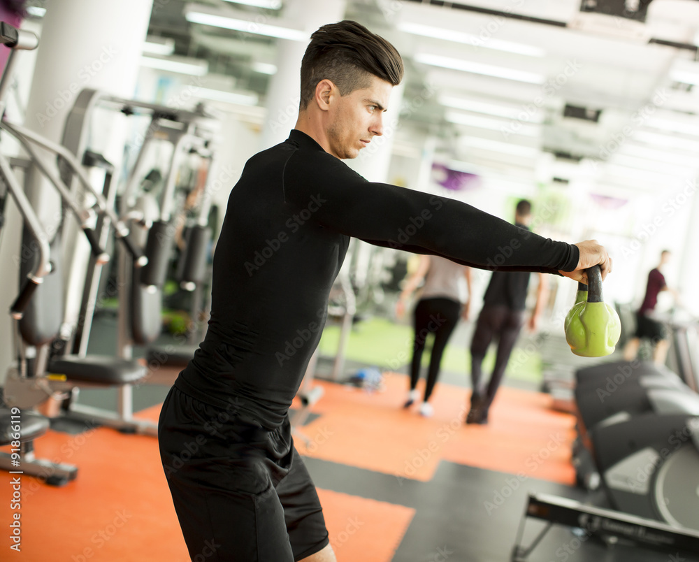 Fototapeta premium Young man training in the gym