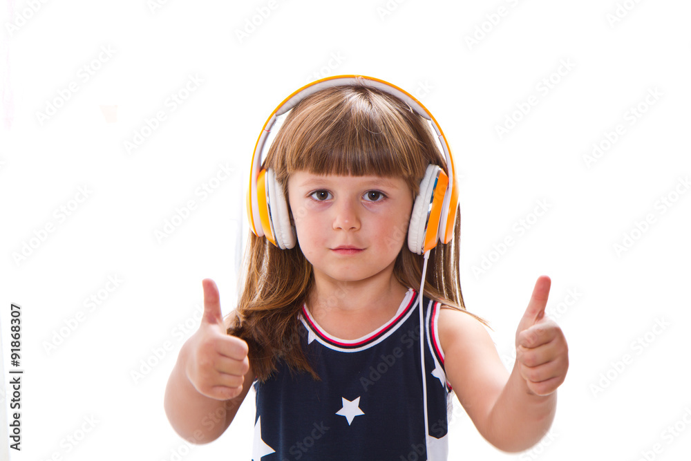 Beautiful cute happy little girl with headphones Beautiful cute happy little girl with headphones