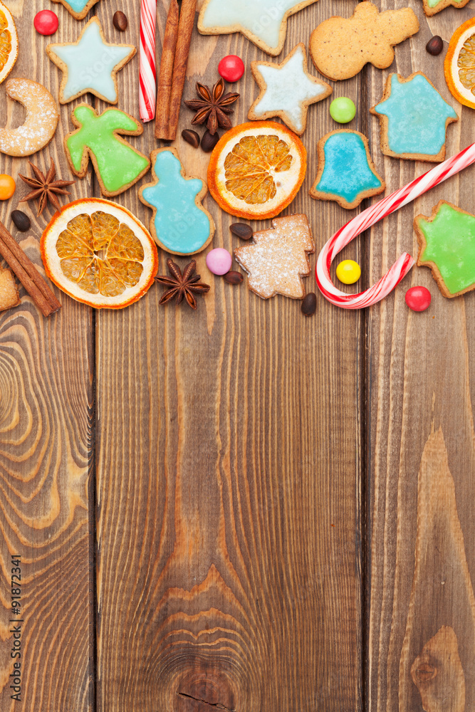 Christmas wooden background with candies, spices, gingerbread co