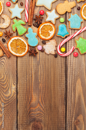 Christmas wooden background with candies, spices, gingerbread co