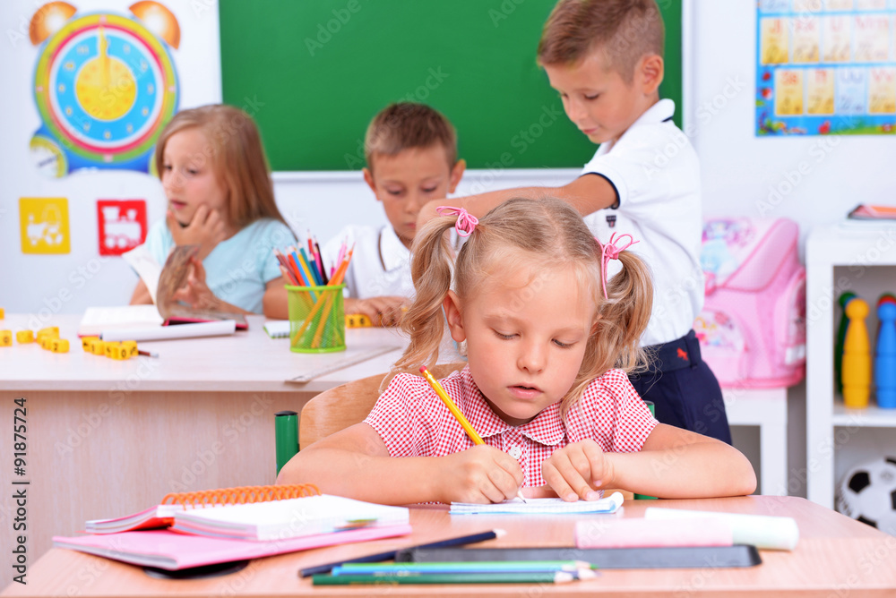 Group of children at the desks in classroom Group of children at the desks in classroom