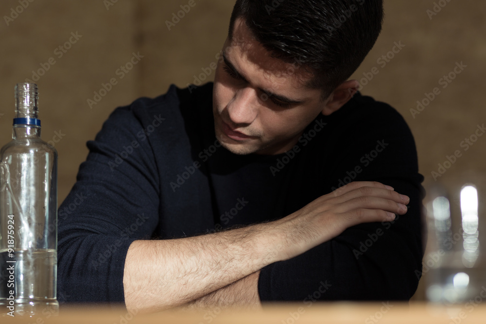 Addicted businessman drinking vodka alone Addicted businessman drinking vodka alone