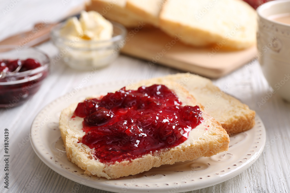 Bread with butter and homemade jam on wooden table, closeup Bread with butter and homemade jam on wooden table, closeup