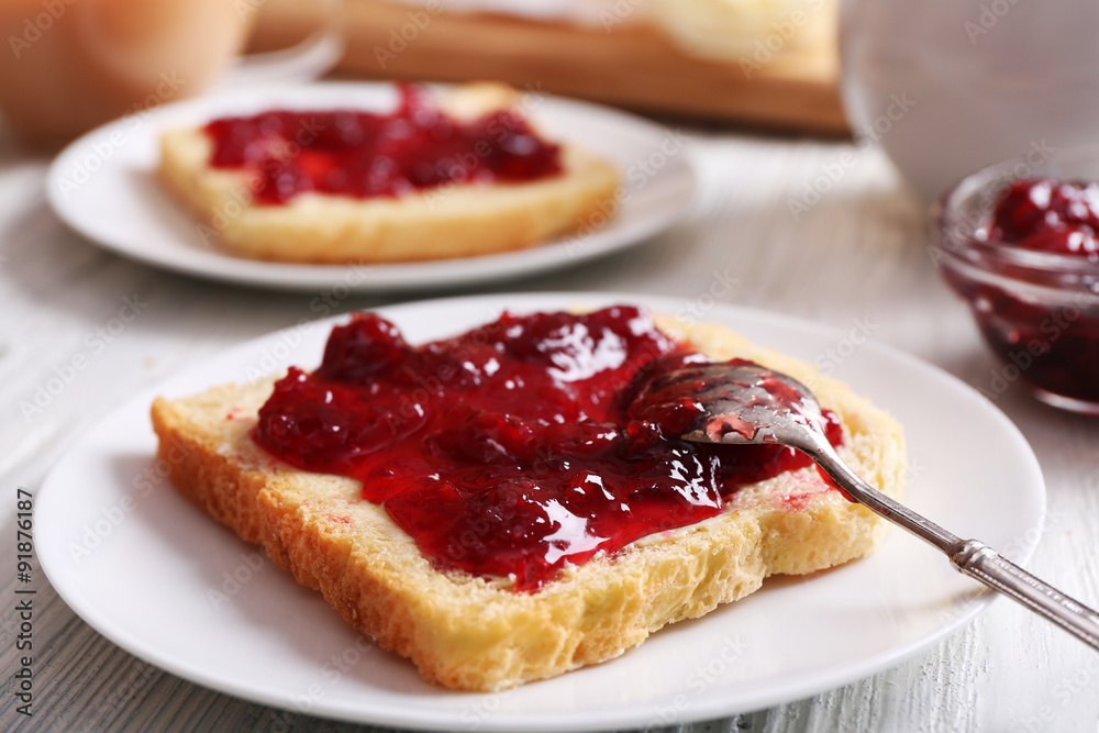 Bread with butter and homemade jam in white plate, closeup Bread with butter and homemade jam in white plate, closeup