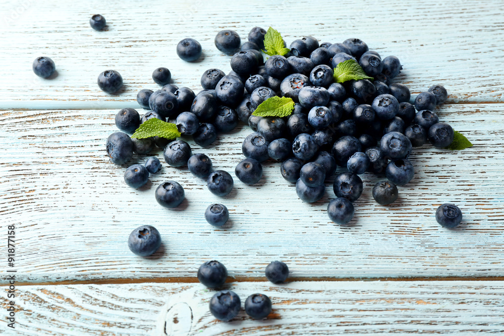 Fresh blueberries with mint on wooden table close up Fresh blueberries with mint on wooden table close up