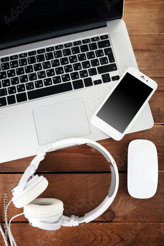 Computer peripherals and laptop accessories on wooden background