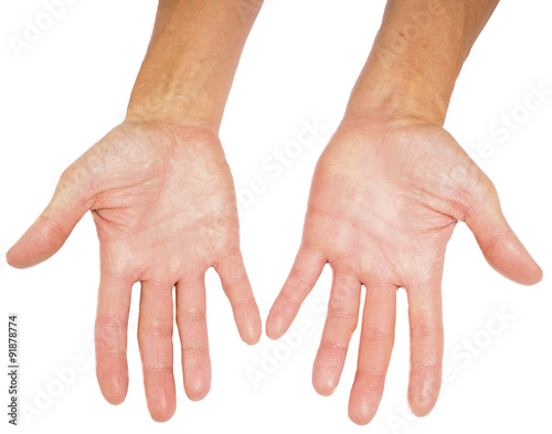 Hands of a male person with fingers spread isolated towards whit