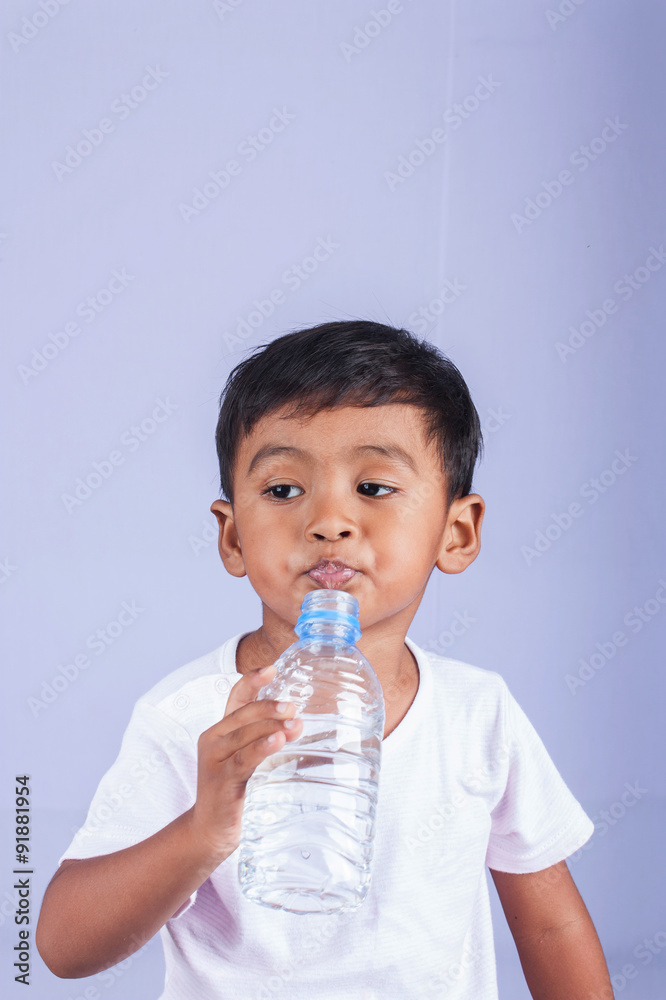 a little asian boy drinking water on white background a little asian boy drinking water on white background