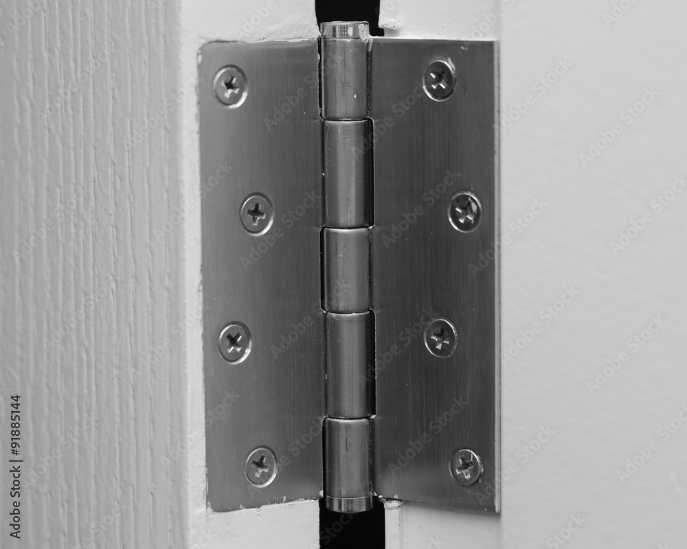 Naklejka premium close up view of stainless door hinges on a white door