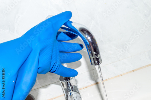 water tap with blue Blue gloves hand 2