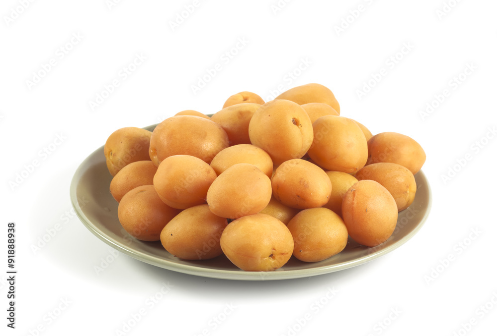 Ripe apricots on a green ceramic plate isolated on white Ripe apricots on a green ceramic plate isolated on white