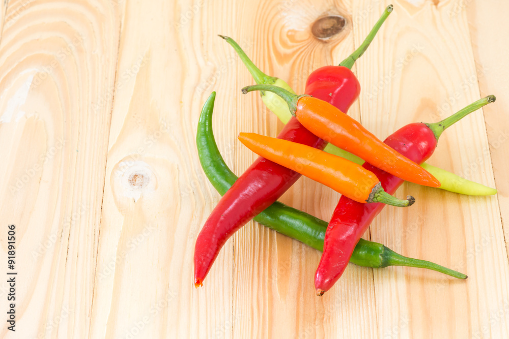 Colorful of sweet chilli on wooden background Colorful of sweet chilli on wooden background