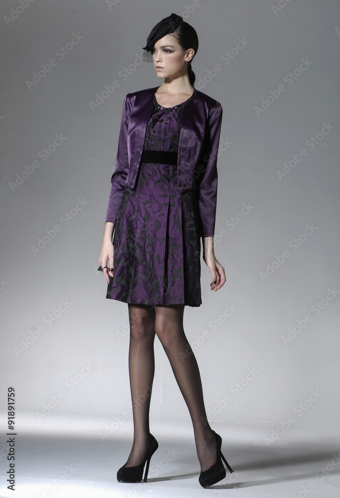 Full length fashion model posing on light background Full length fashion model posing on light background