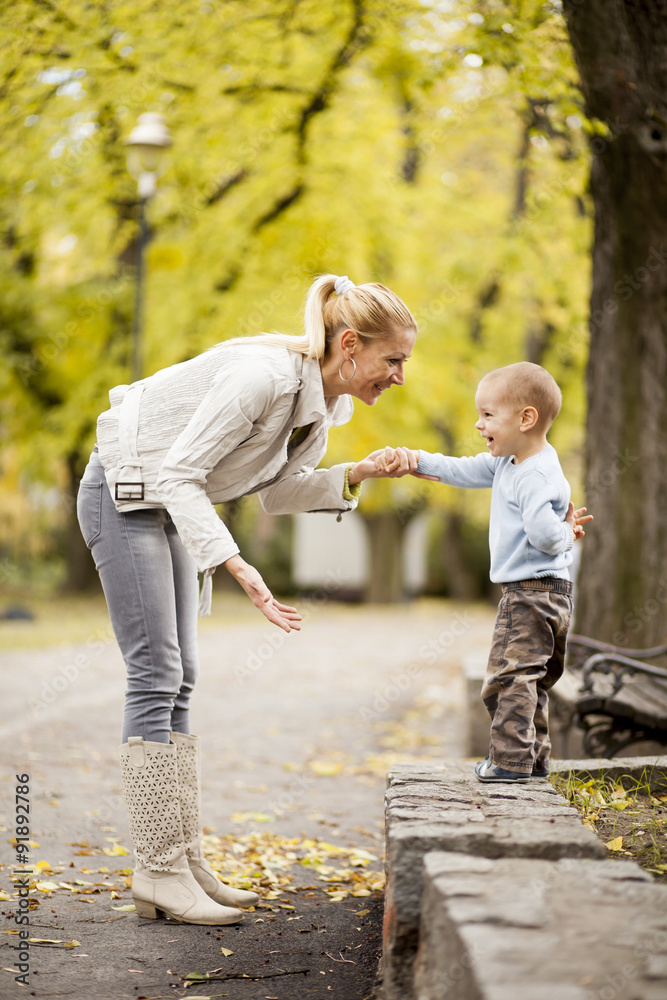 Fototapeta premium Mother and son in the autumn forest