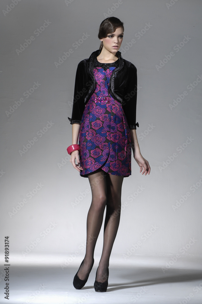 full-length portrait of young model posing on light background
full-length portrait of young model posing on light background