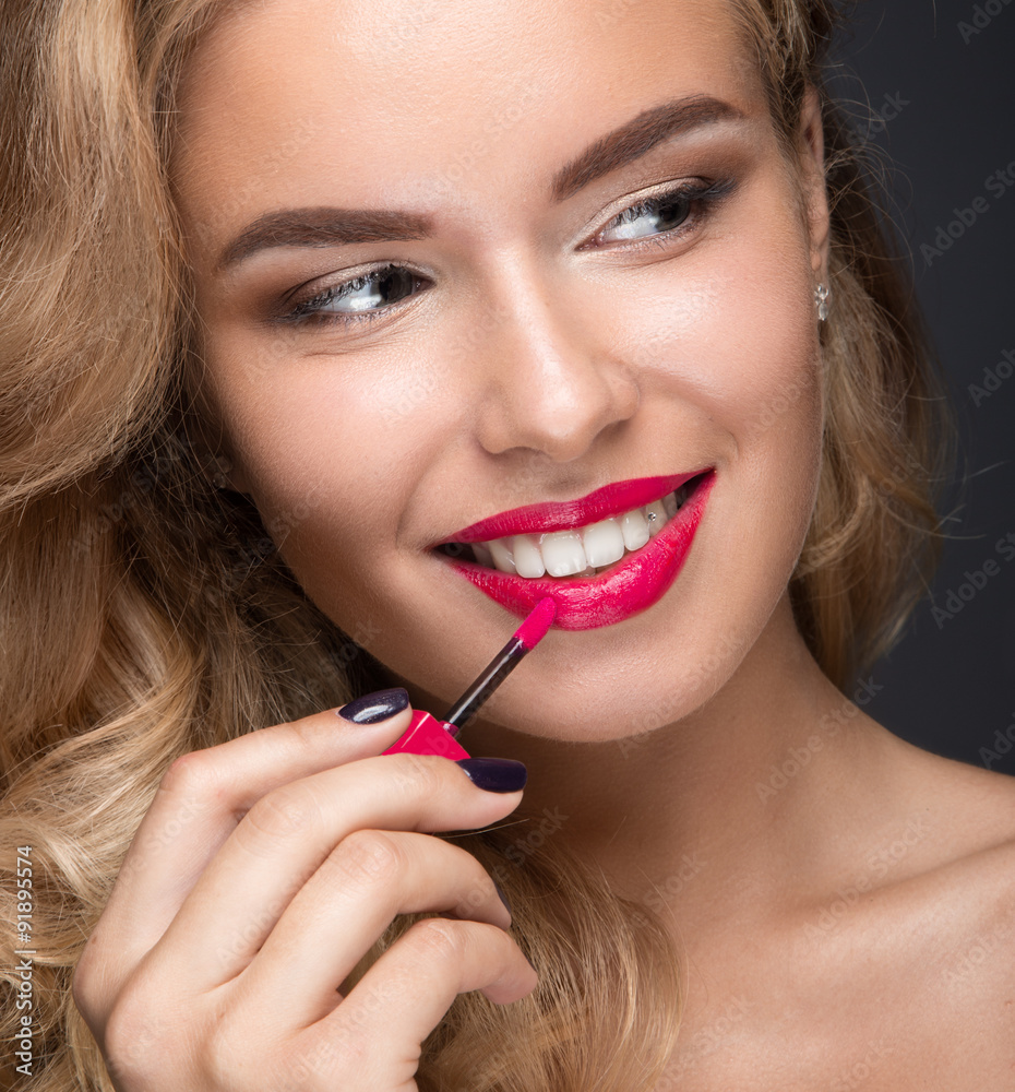 Beautiful blonde girl with curls, red lips and a smile on her Beautiful blonde girl with curls, red lips and a smile on her