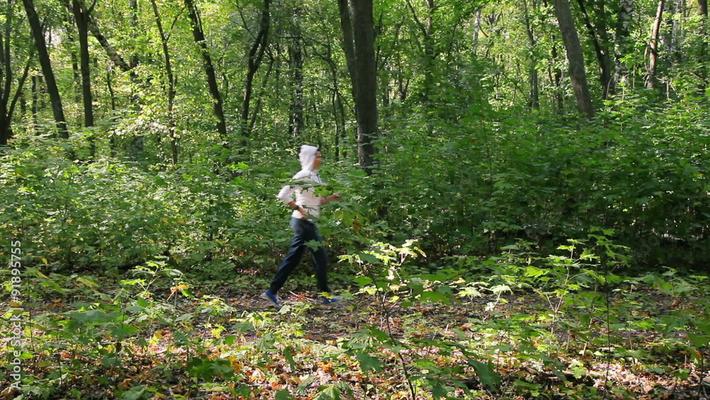 attractive woman running along path in park
attractive woman running along path in park