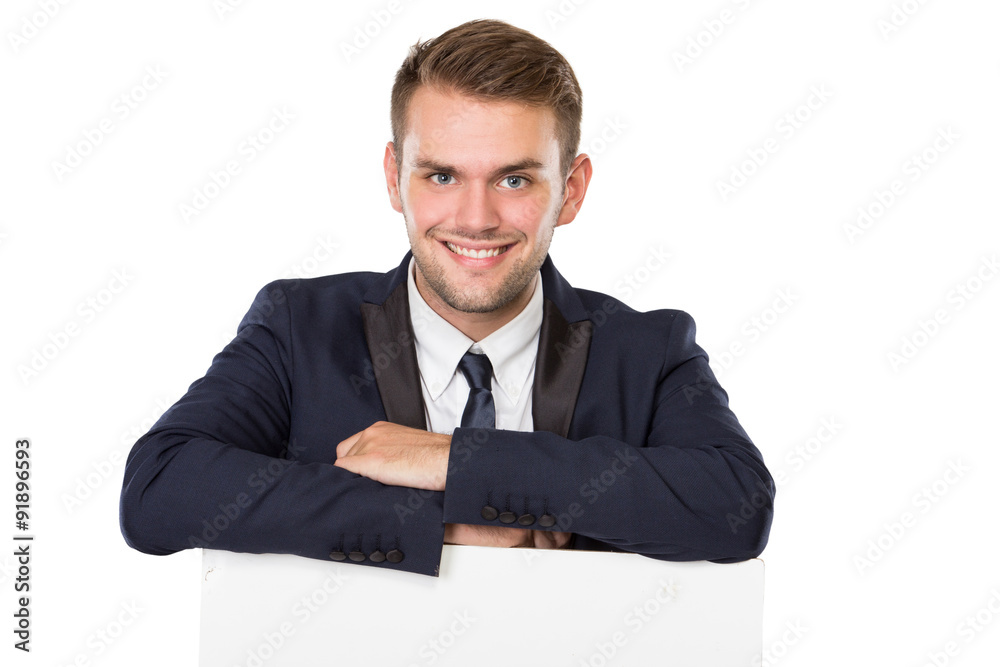Businessman standing next to a blank white billboard Businessman standing next to a blank white billboard