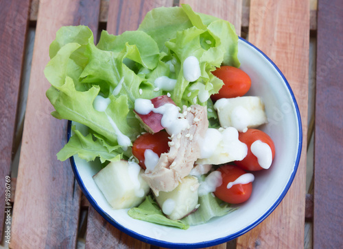 Fresh healthy salad in old cup photo