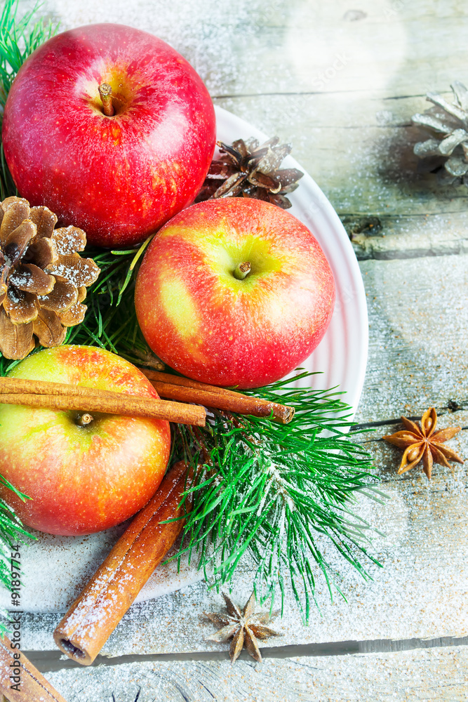 Christmas composition on a platter: apples, tree branches