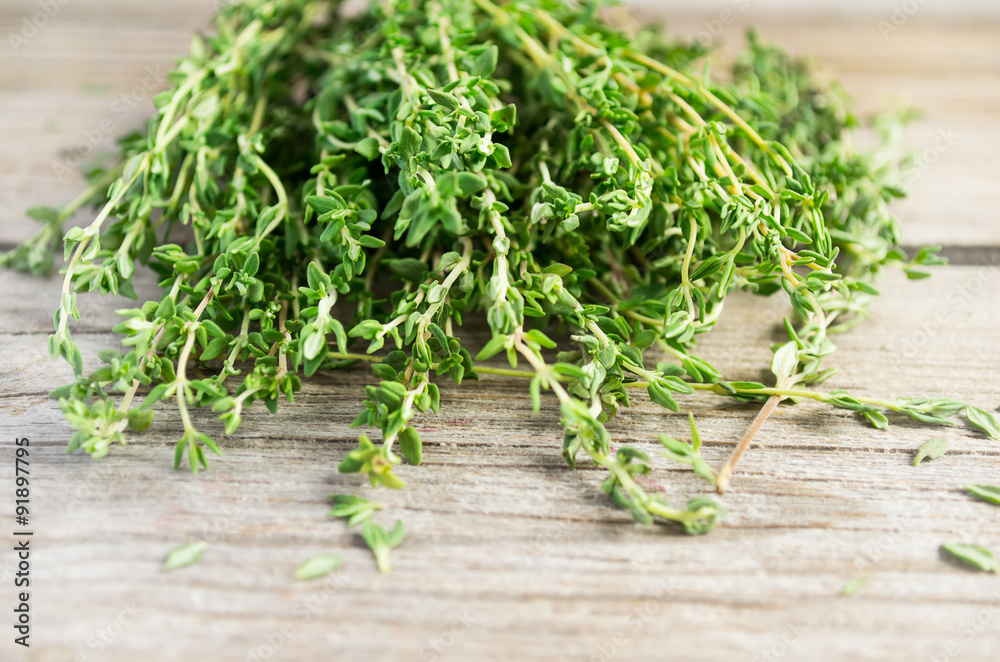 Sprigs of thyme on an old wooden background Sprigs of thyme on an old wooden background