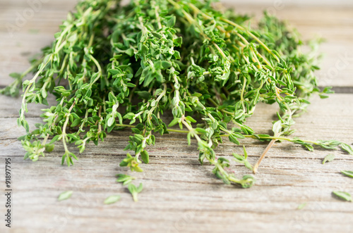Sprigs of thyme on an old wooden background