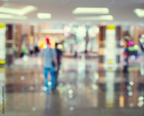 Blurred Background  people go for Shopping Mall along the window