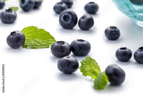 blueberries and mint leaves on white background