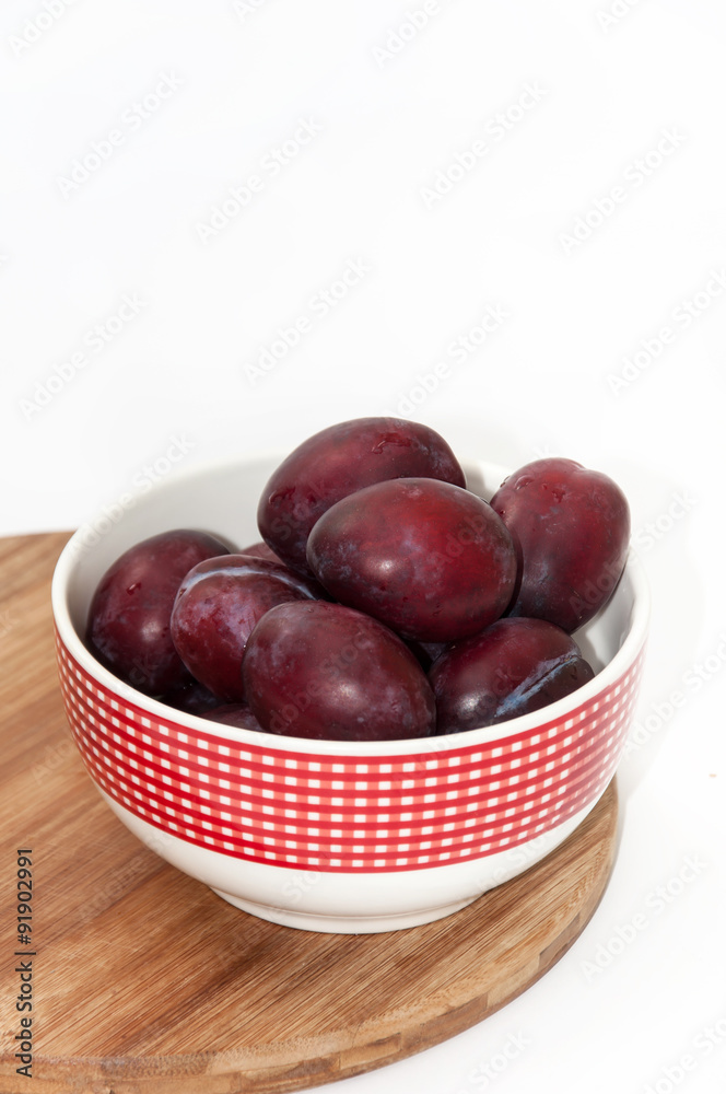 Fresh violet plums in the bowl Fresh violet plums in the bowl