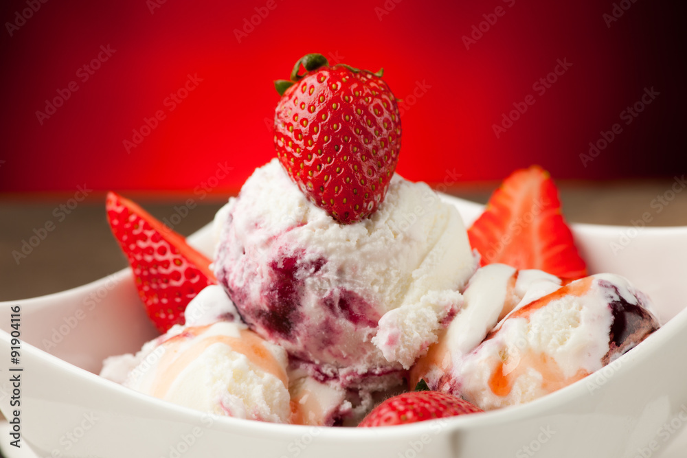 Strawberry icecream in a white bowl with strawberries Strawberry icecream in a white bowl with strawberries