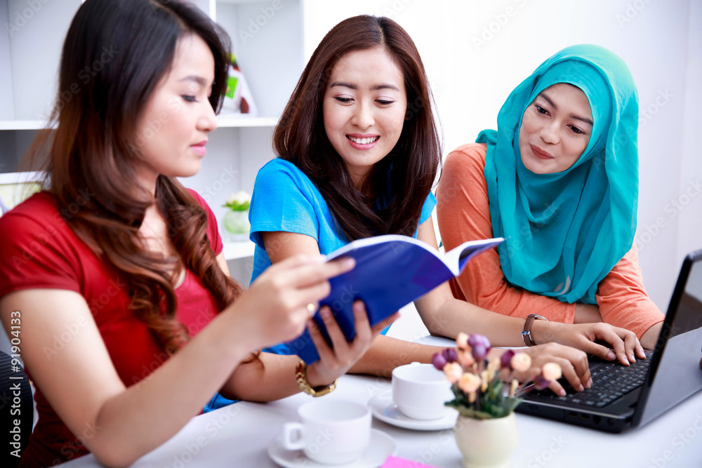 three college students discussing about their lecture subject three college students discussing about their lecture subject