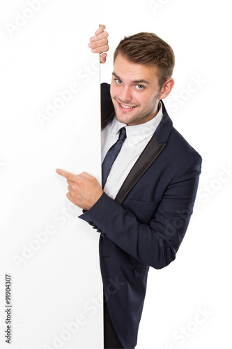 Businessman standing next to a blank white billboard