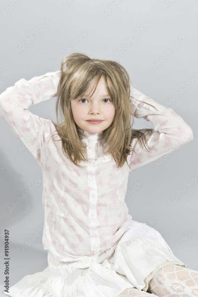 Portrait of a five year old girl sitting on the floor with his h Portrait of a five year old girl sitting on the floor with his h