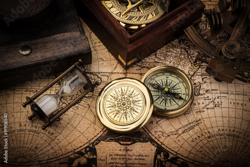 Old compass, astrolabe on vintage map. Retro stale.