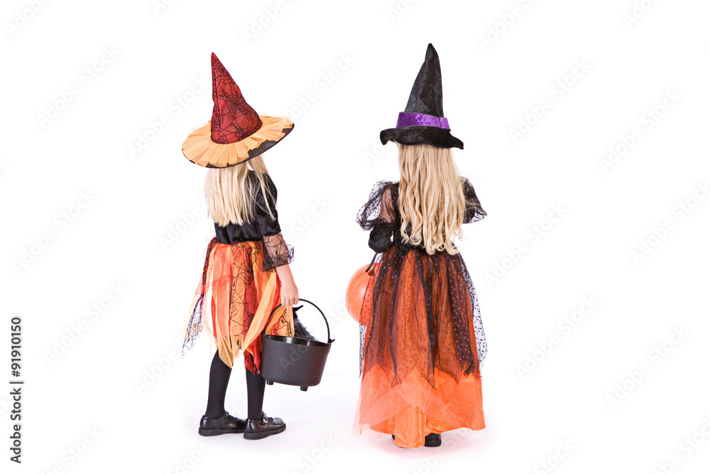Halloween: Rear View Of Two Trick Or Treat Witches
