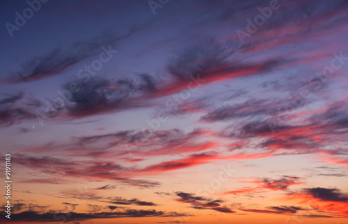 Dramatic sunset sky with colored clouds. Toned image.