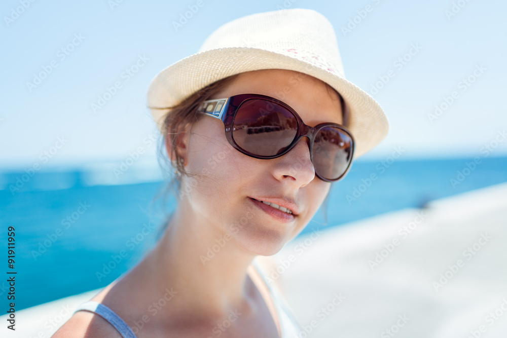 Girl on the waterfront in sunglasses and hat Girl on the waterfront in sunglasses and hat