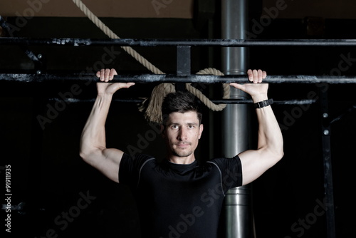 Athlete Fitness trainer working out / weight lifting in a gym