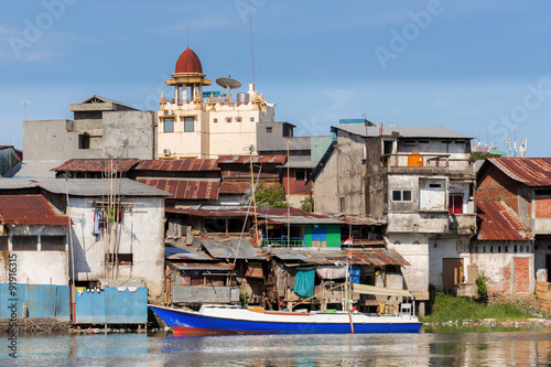 Фотография Straw poor houses by the river
