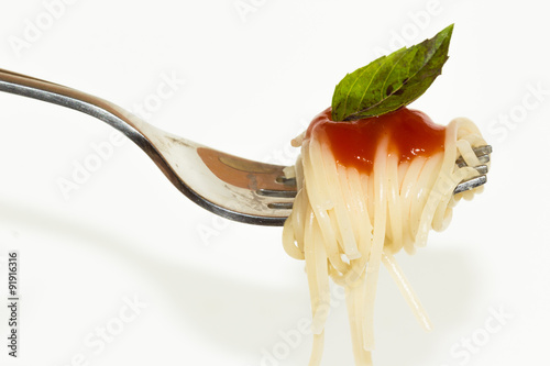 Pasta with sauce on the fork isolated on white