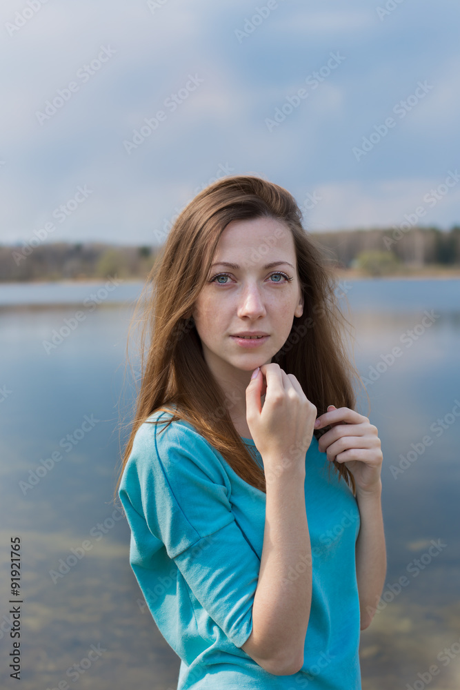 Freckled happy girl looking at camera and dreaming Freckled happy girl looking at camera and dreaming