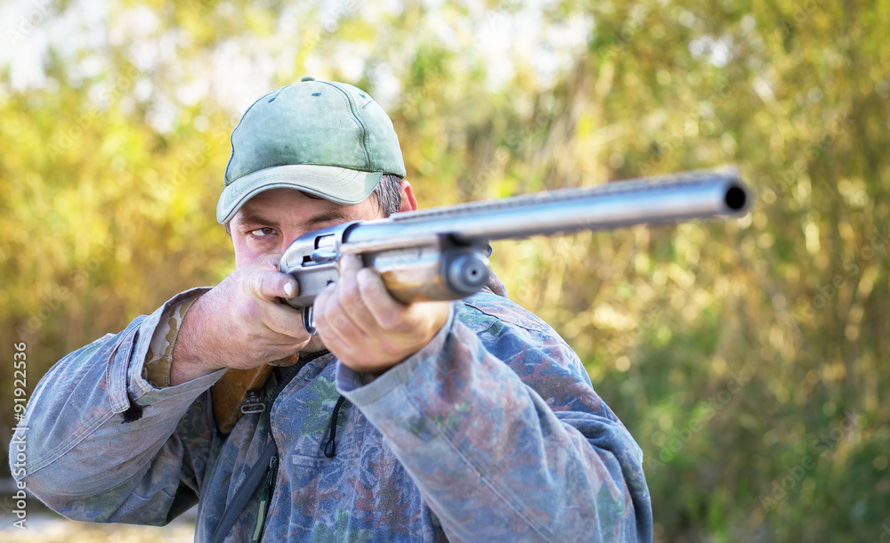 Fototapeta premium Hunter taking aim at the target. Hunter with a gun.