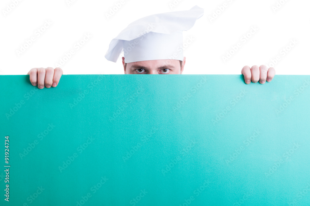 Cook or chef looking over green wall with advertising space Cook or chef looking over green wall with advertising space