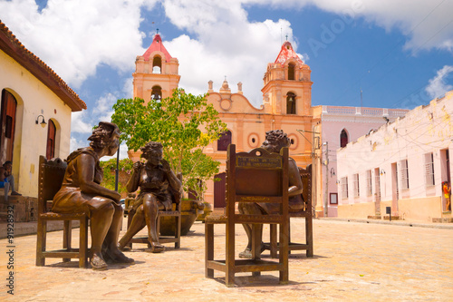 CAMAGUEY, CUBA - SEPTEMBER 4, 2015: Statues, artist Martha Jimenez in front of the Carmen church photo