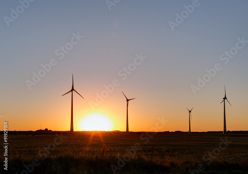 Wind power plant during sunset time. Lithuania.