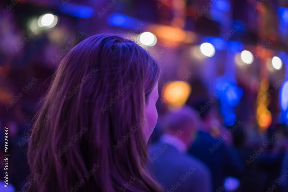 Young woman with colorful background lights